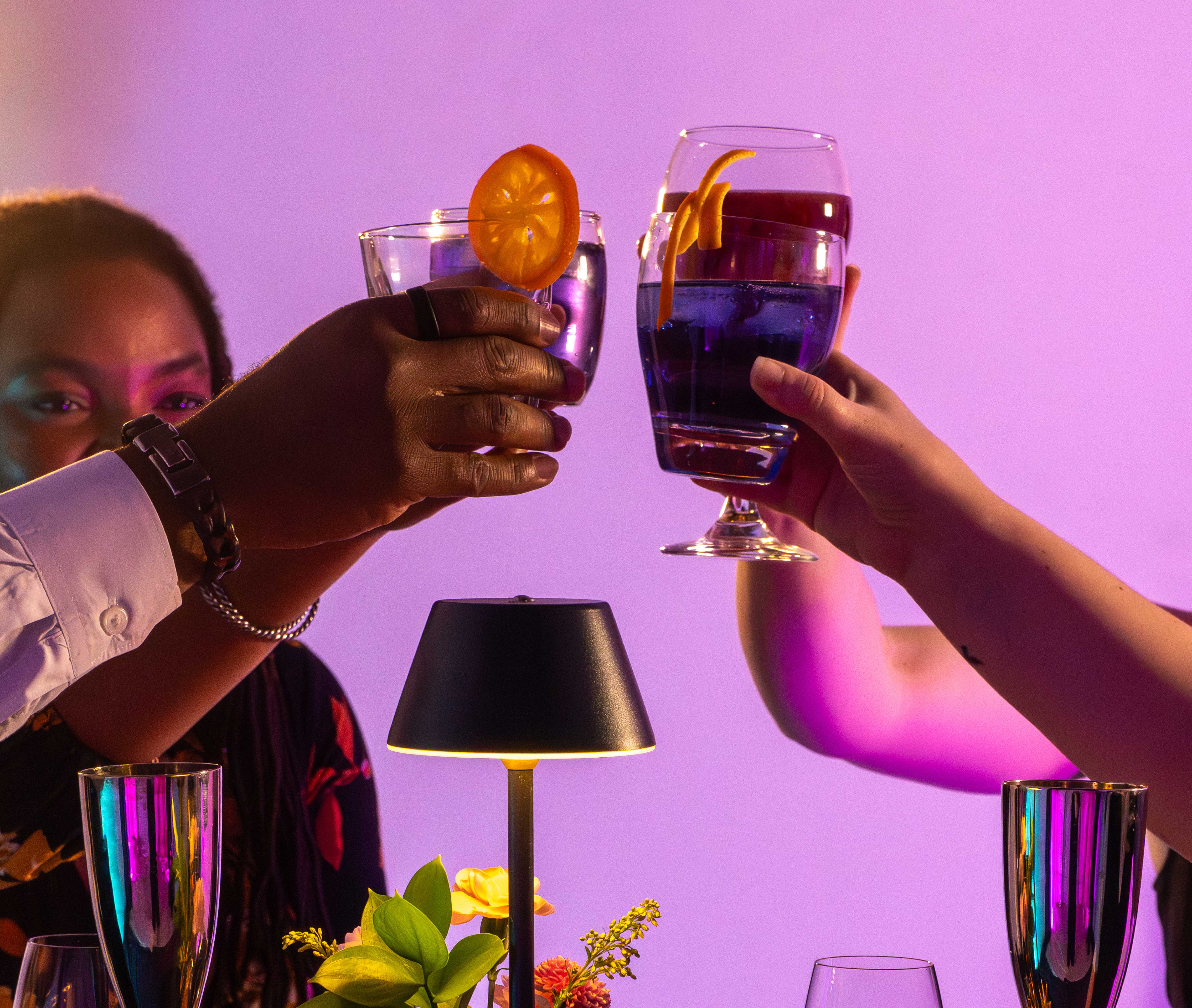 Guests raising cocktails together at a Bèl Rèv dinner